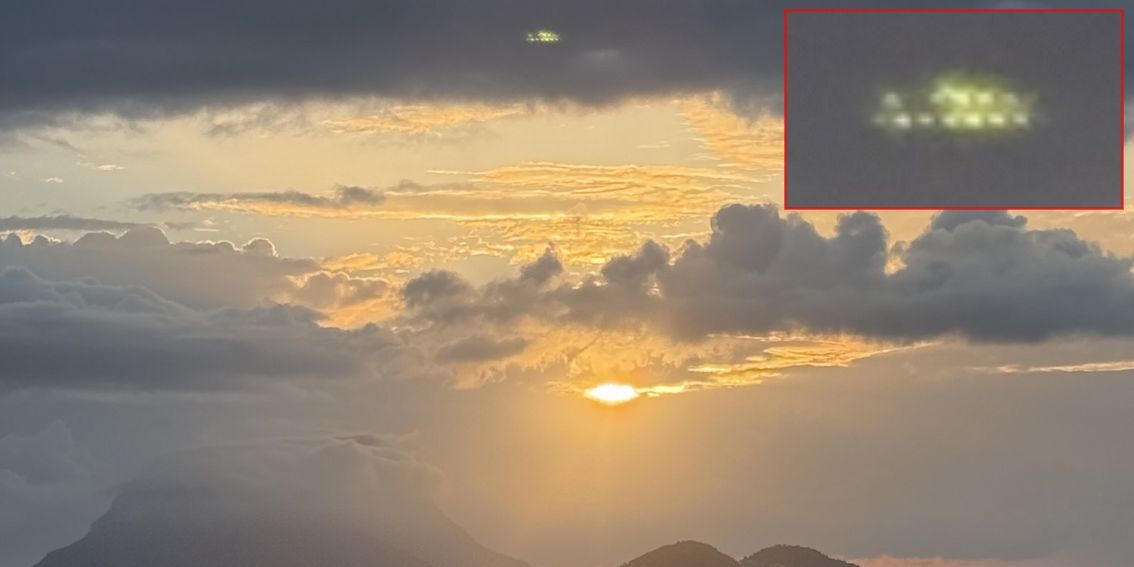 Spanien 2025 - Linsenreflexion Oberhalb der aufgehenden Sonne ein grün wirkendes ovales Objekt, das viele kleine helle Lichter/Flächen aufweist.